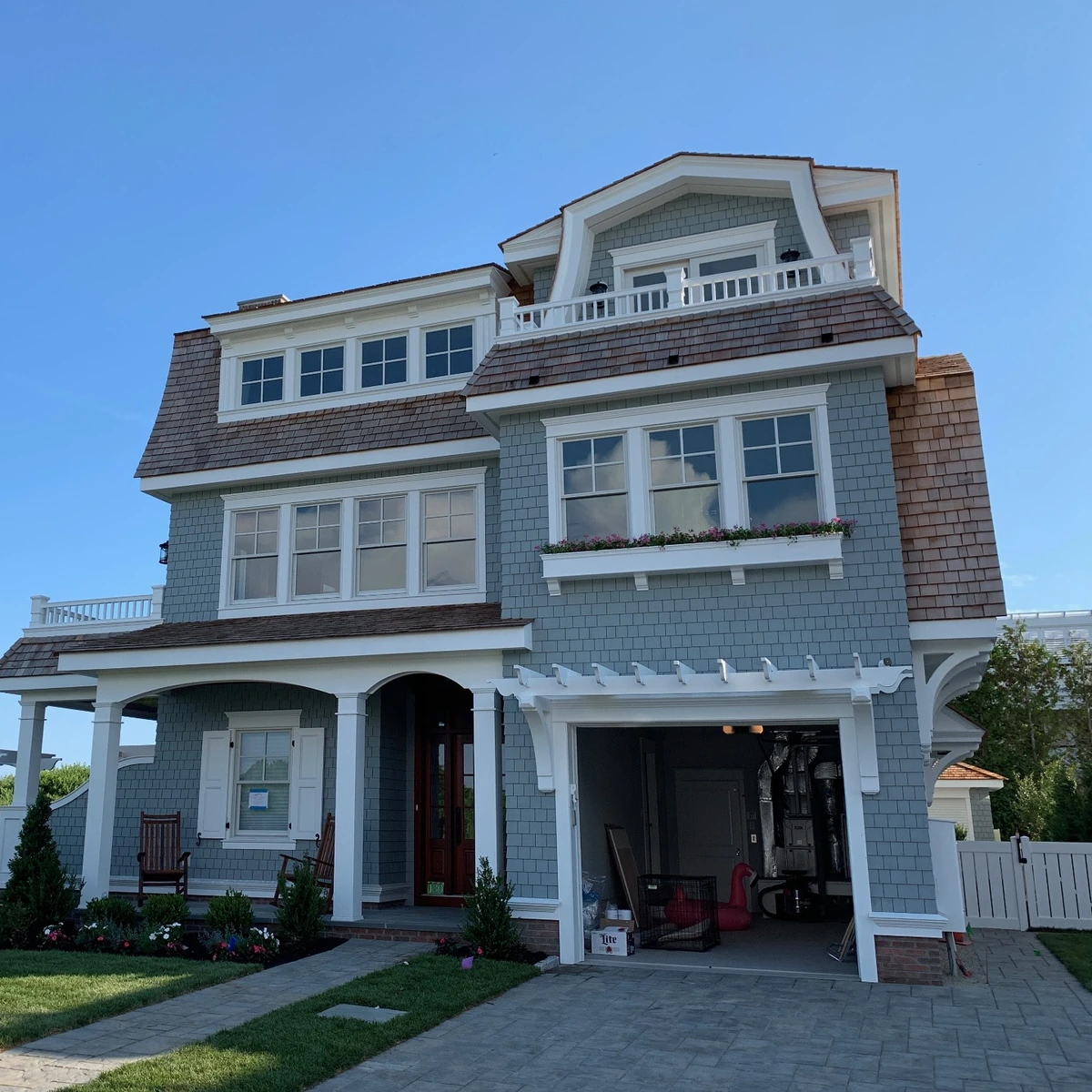 Gray shingle siding and white exterior trim on a coastal home